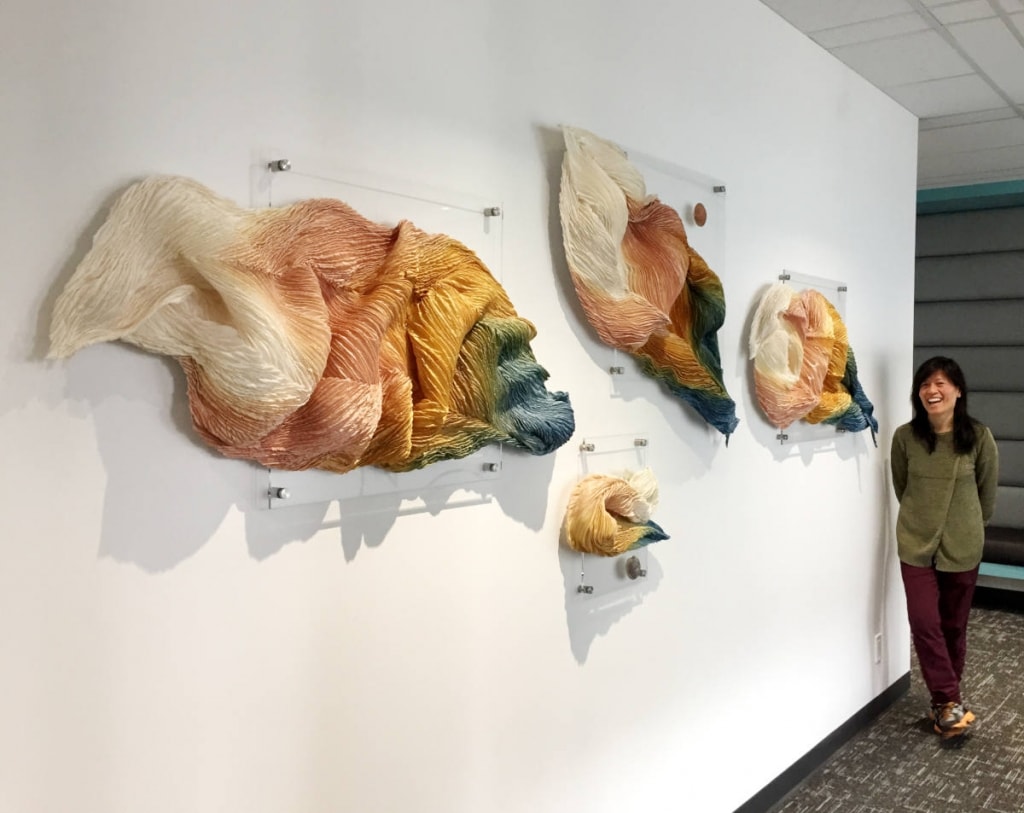 Textile Artist Daphne Woo | “Water is Life” | created for the offices of SFU Beedie School of Business in Vancouver. Consisting of 4 mounted pieces of 100% Silk, naturally dyed with avocado pits + peels, eucalyptus leaves, onion skin, and indigo. Using Arashi Shibori technique.
